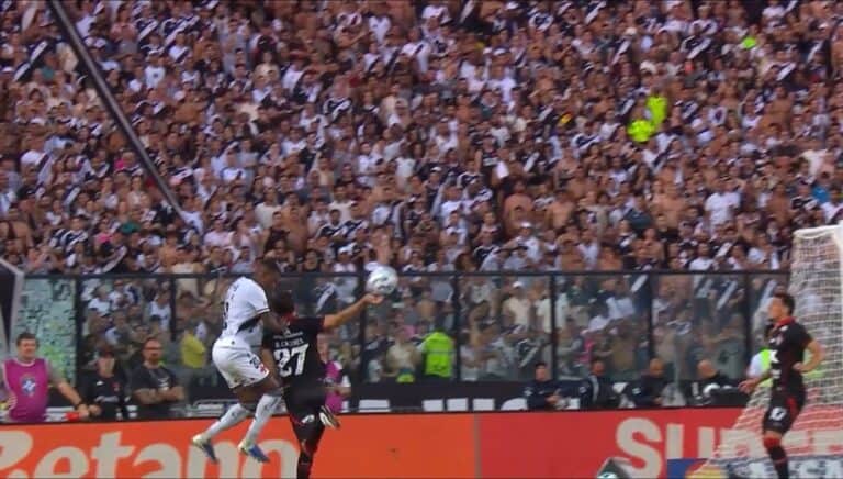 Jogadores disputando a bola durante partida de futebol.