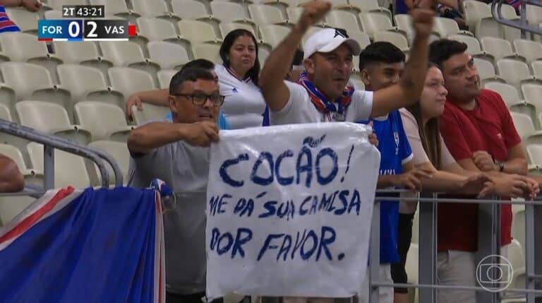Catorze amigos vestindo camisas do Vasco, apoiando o time no estádio.