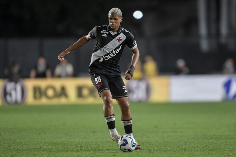 Jogador do Vasco em campo durante jogo noturno.