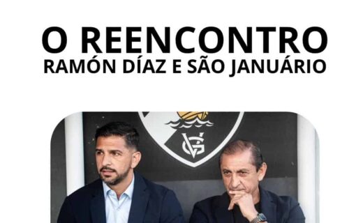 Reunião entre Ramón Díaz e São Januário, estádio do Vasco, com dois homens de terno sentado, fundo com escudo do clube. Encontro importante do técnico com o clube.