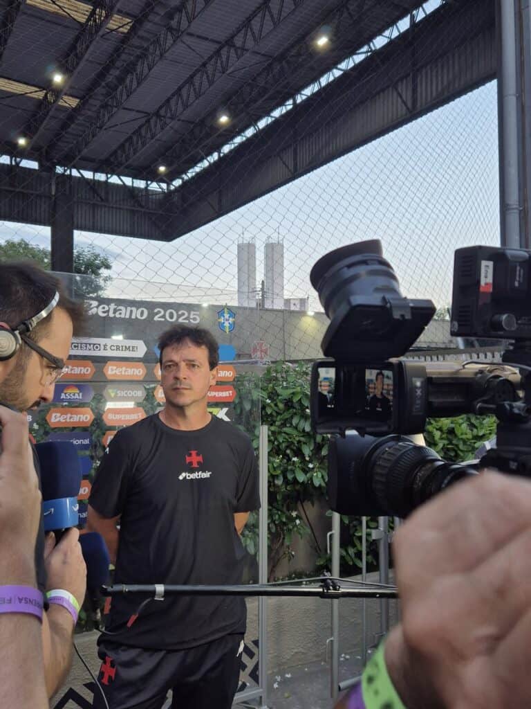 Profissional de futebol em entrevista à imprensa no estádio.